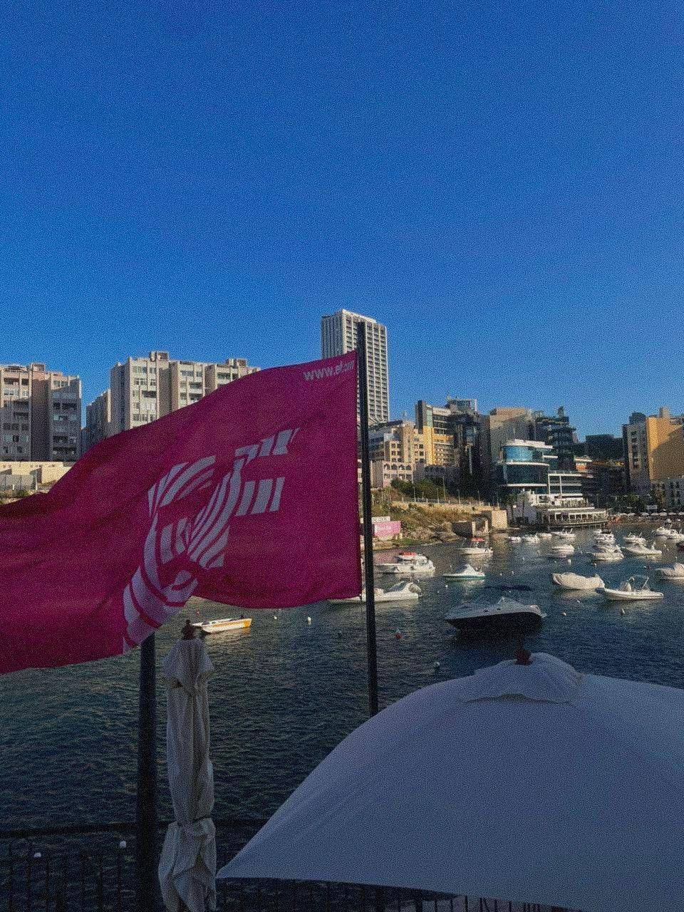 An EF flag flying over a bay full of boats in Malta
