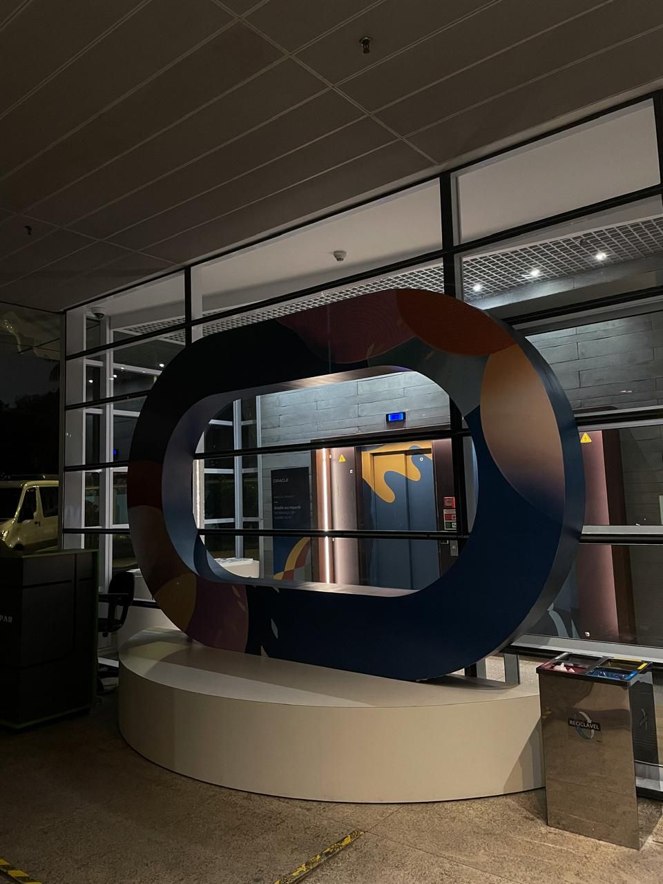 The Oracle logo sculpture in the office lobby at night